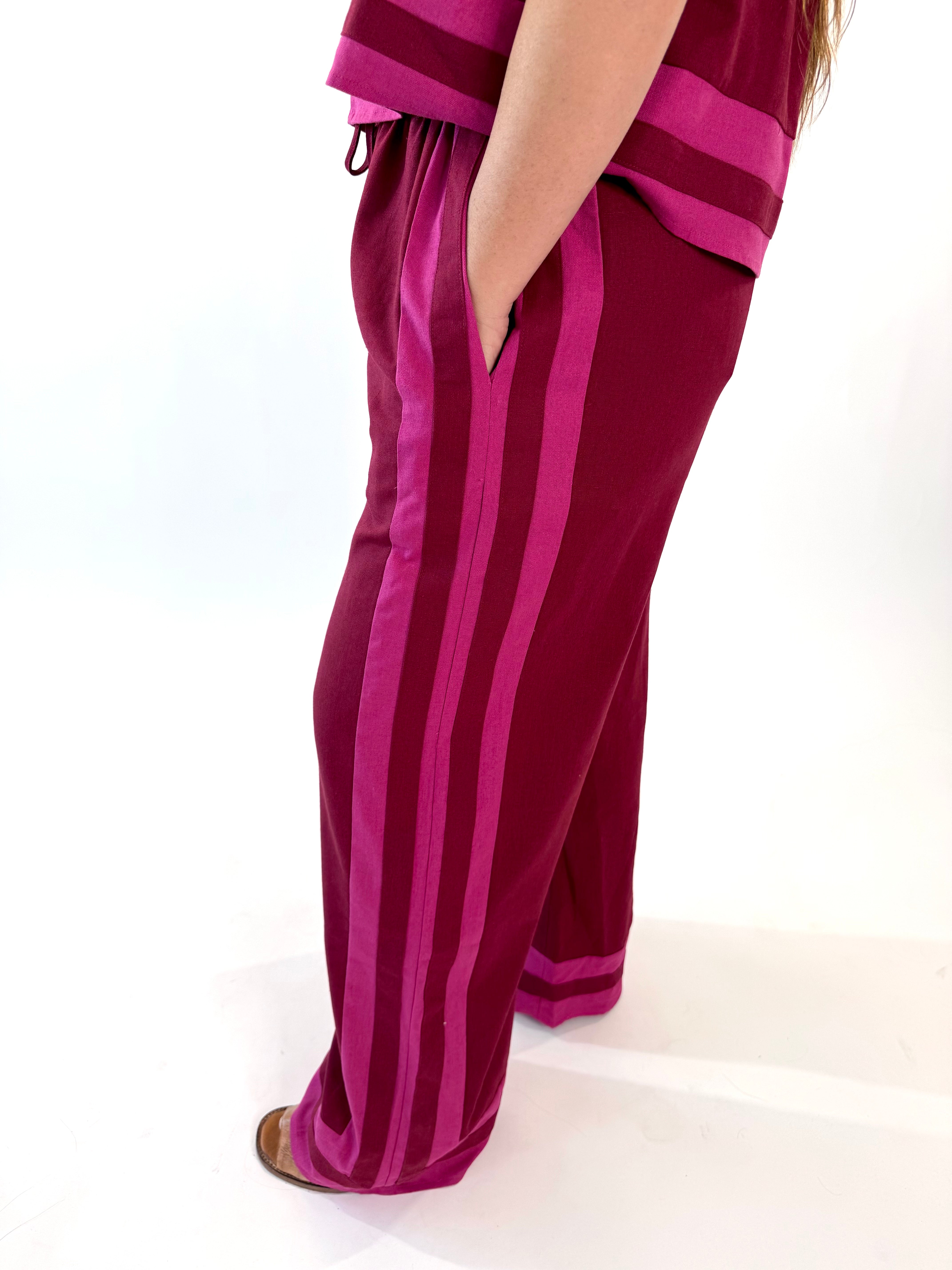 Maroon striped pants on a white background