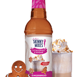 A bottle of Skinny Mixes Gingerbread Latte syrup with a decorative gingerbread man and a glass of a gingerbread latte with whipped cream.