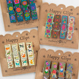 Set of Happy Clips with colorful designs on brown packaging