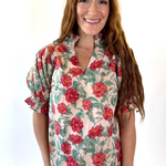Woman wearing a floral blouse with a white background