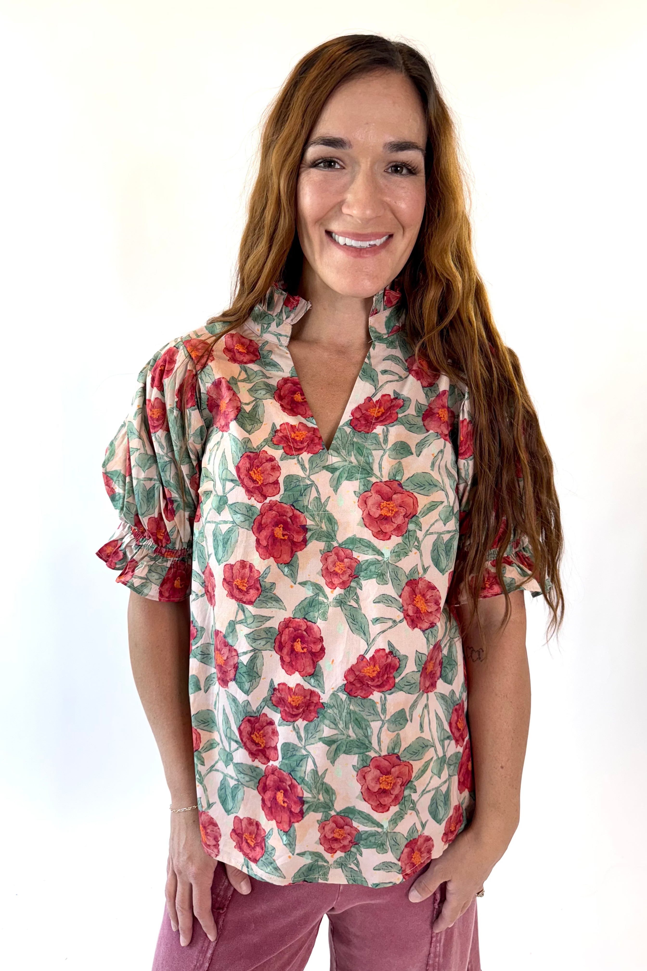 Woman wearing a floral blouse with a white background