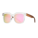 Sunglasses with pink reflective lenses and wooden arms on a white background