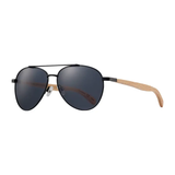 Sunglasses with dark lenses and wooden arms on a white background