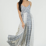 Woman wearing a floral patterned dress on a white background