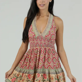 Woman wearing a patterned dress with a plain background