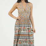 Woman wearing a patterned dress on a white background | Clementine Printed Halter Maxi Dress