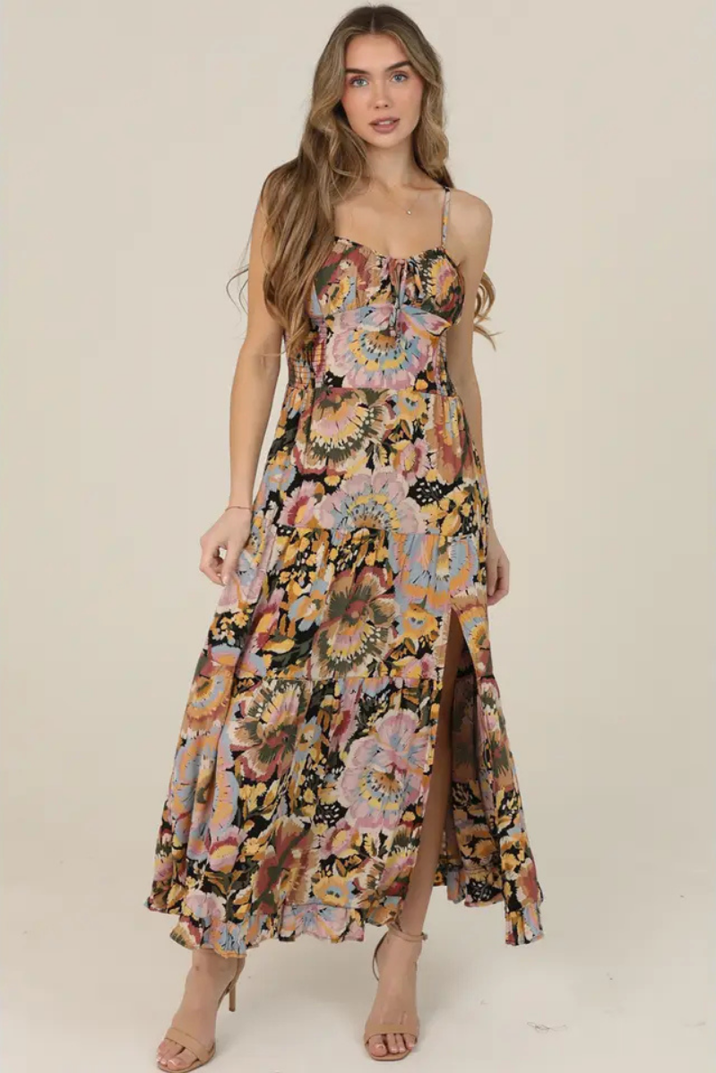 Woman wearing a floral dress on a plain background | Floral Tie Bust Maxi Dress with Side Slit