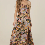 Woman wearing a floral dress on a plain background | Floral Tie Bust Maxi Dress with Side Slit