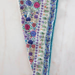 Floral-patterned headband on a light wooden surface