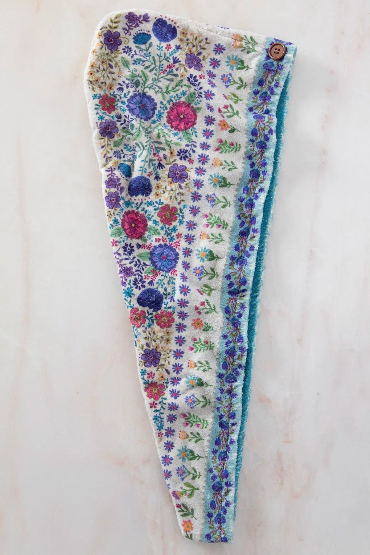 Floral-patterned headband on a light wooden surface