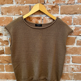 Brown sleeveless sweater vest on a wooden hanger against a brick wall.