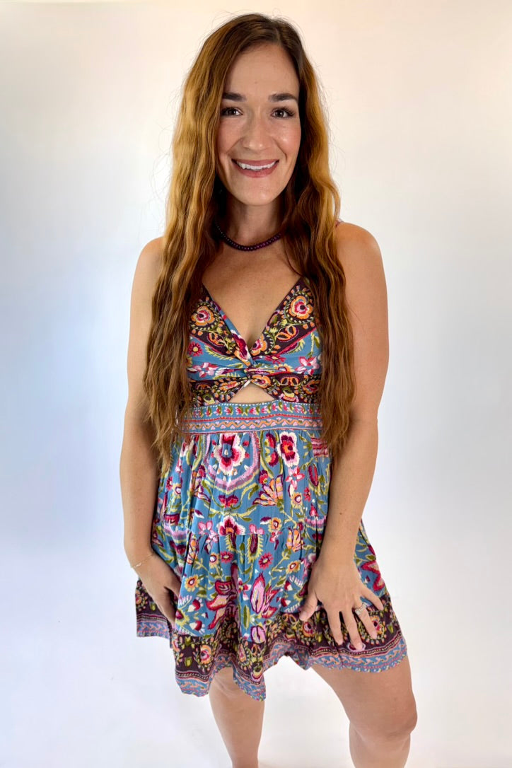 Woman wearing a colorful floral dress on a white background