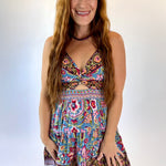 Woman wearing a colorful floral dress on a white background