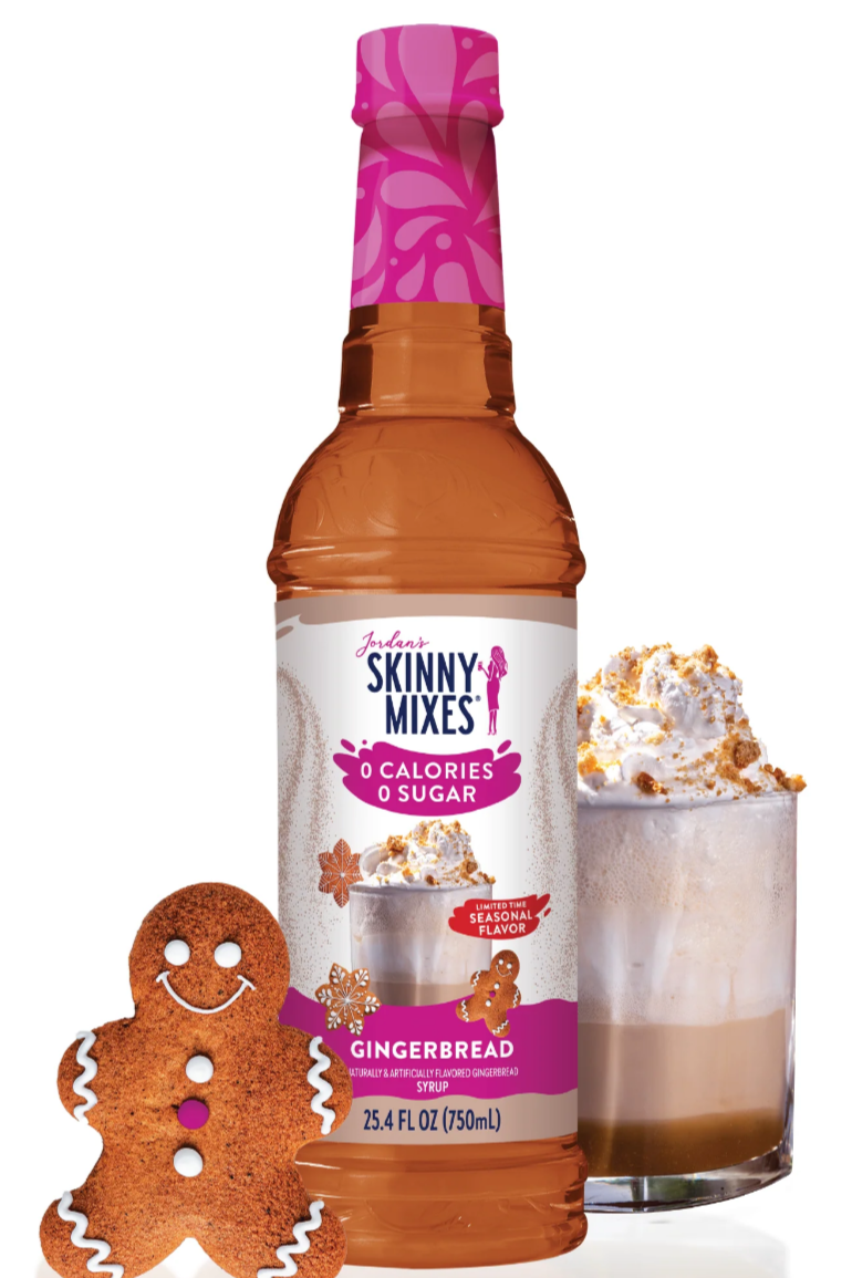 A bottle of Skinny Mixes Gingerbread Latte syrup with a decorative gingerbread man and a glass of a gingerbread latte with whipped cream.