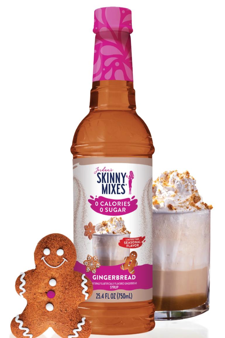 A bottle of Skinny Mixes Gingerbread Latte syrup with a decorative gingerbread man and a glass of a gingerbread latte with whipped cream.