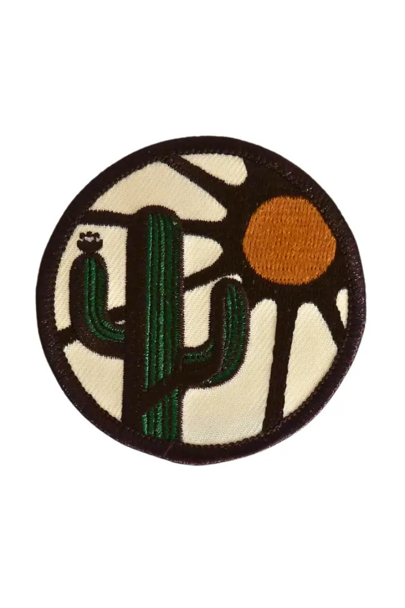 Circular patch with a cactus and sun design on a beige background