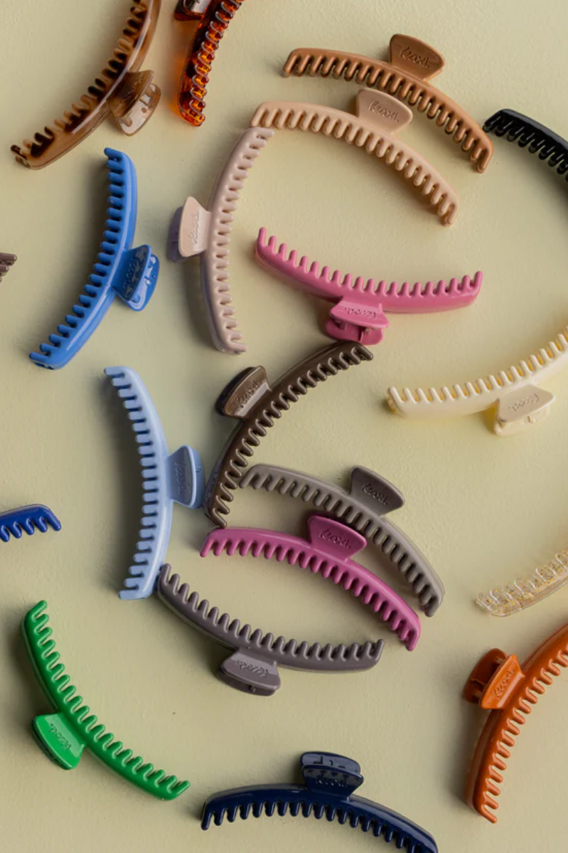 Colorful hair clips scattered on a light background