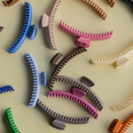 Colorful hair clips scattered on a light background