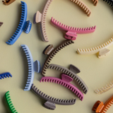 Colorful hair clips scattered on a light background