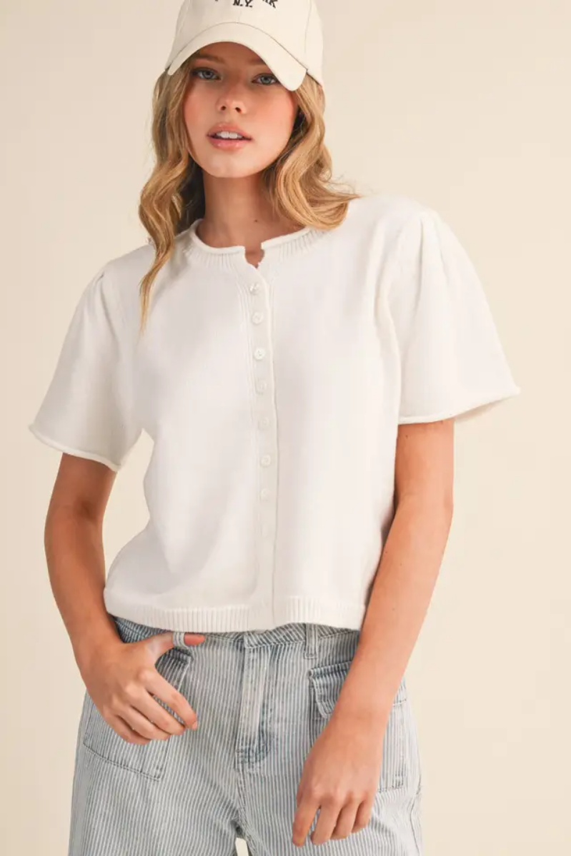 Girl standing with white cardigan on 