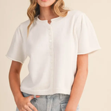 Girl standing with white cardigan on 