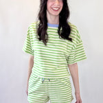 Person wearing a green and white striped outfit on a white background