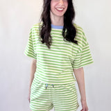 Person wearing a green and white striped outfit on a white background