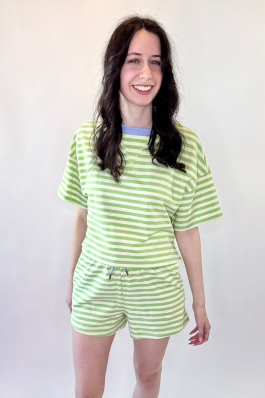 Person wearing a green and white striped outfit on a white background