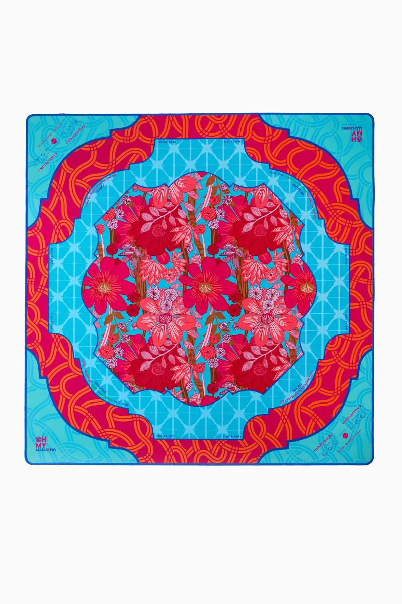 Colorful Tile/Game mat in a floral design on a blue background with red border. Delilah Mat in Tube | Oh My Mahjong
