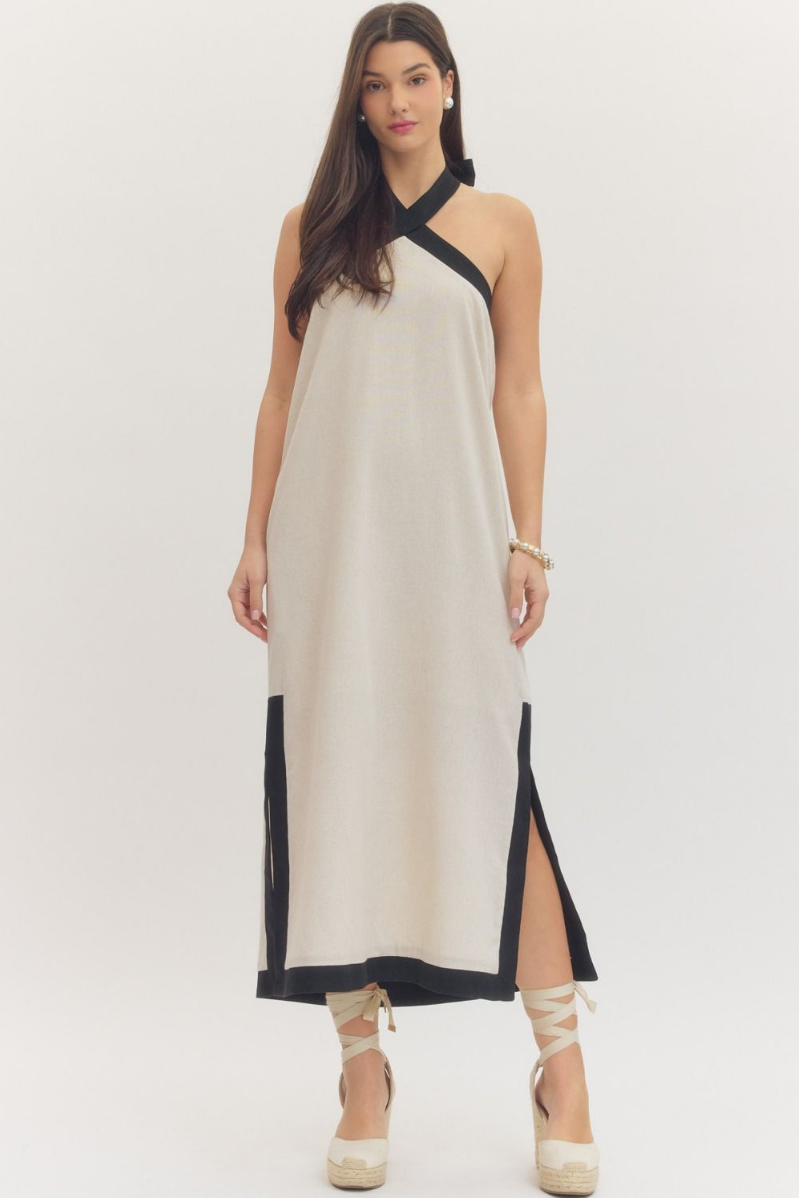 Woman wearing a white dress with black accents on a white background