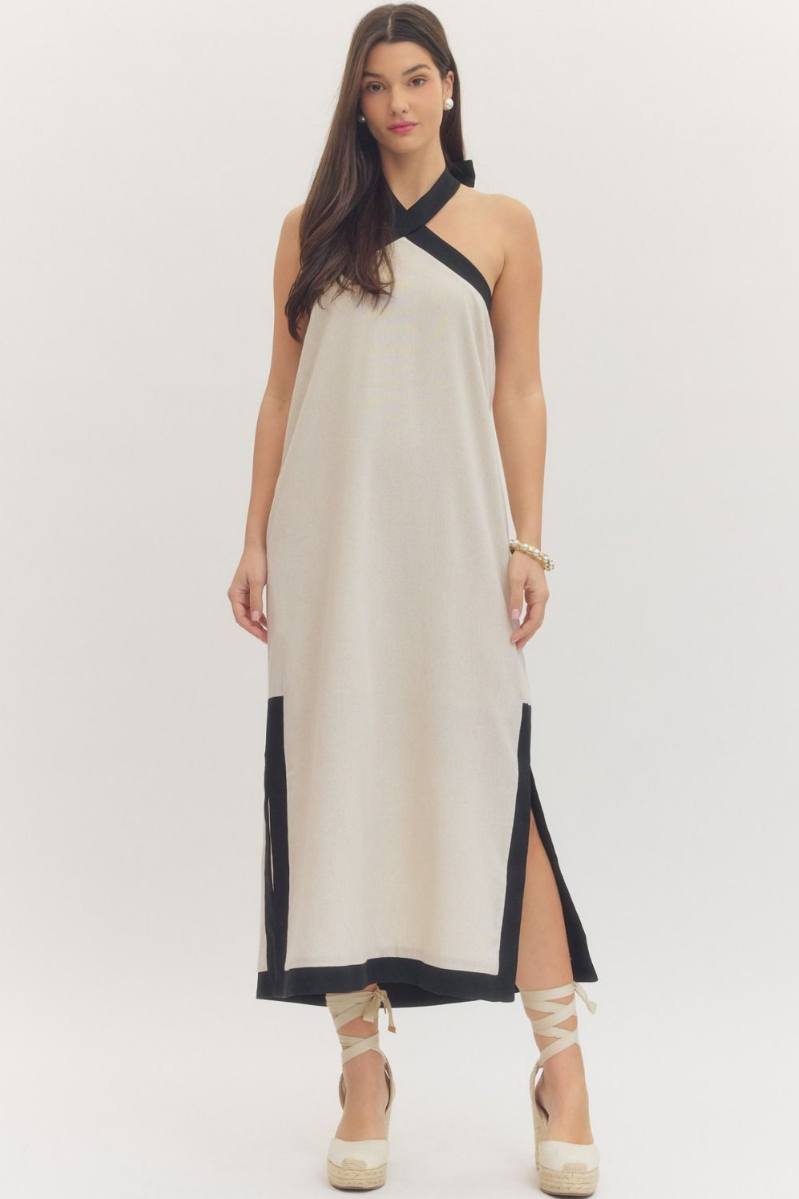 Woman wearing a white dress with black accents on a white background