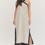 Woman wearing a white dress with black accents on a white background