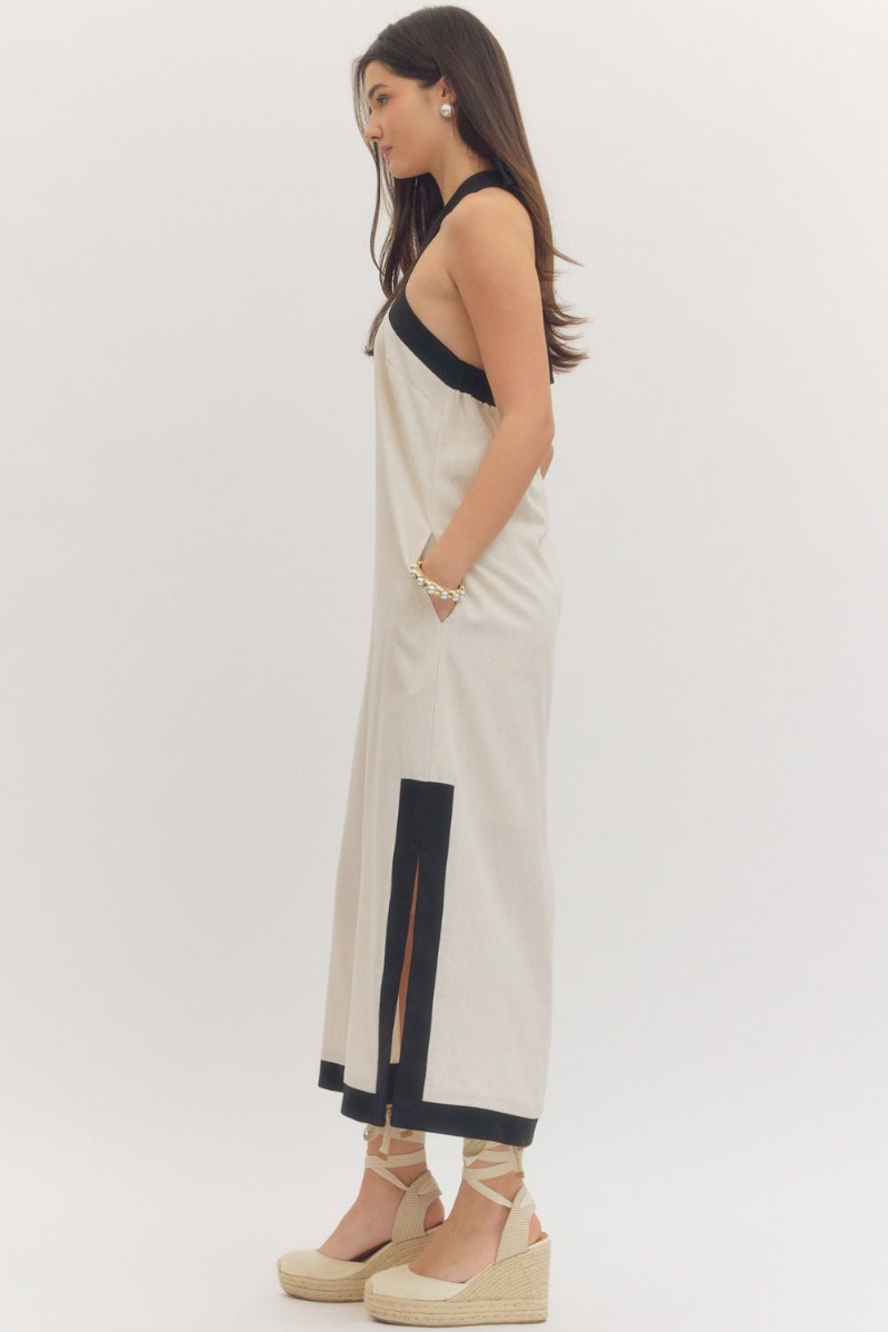 Woman wearing a beige and black dress on a white background