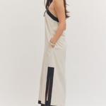 Woman wearing a beige and black dress on a white background