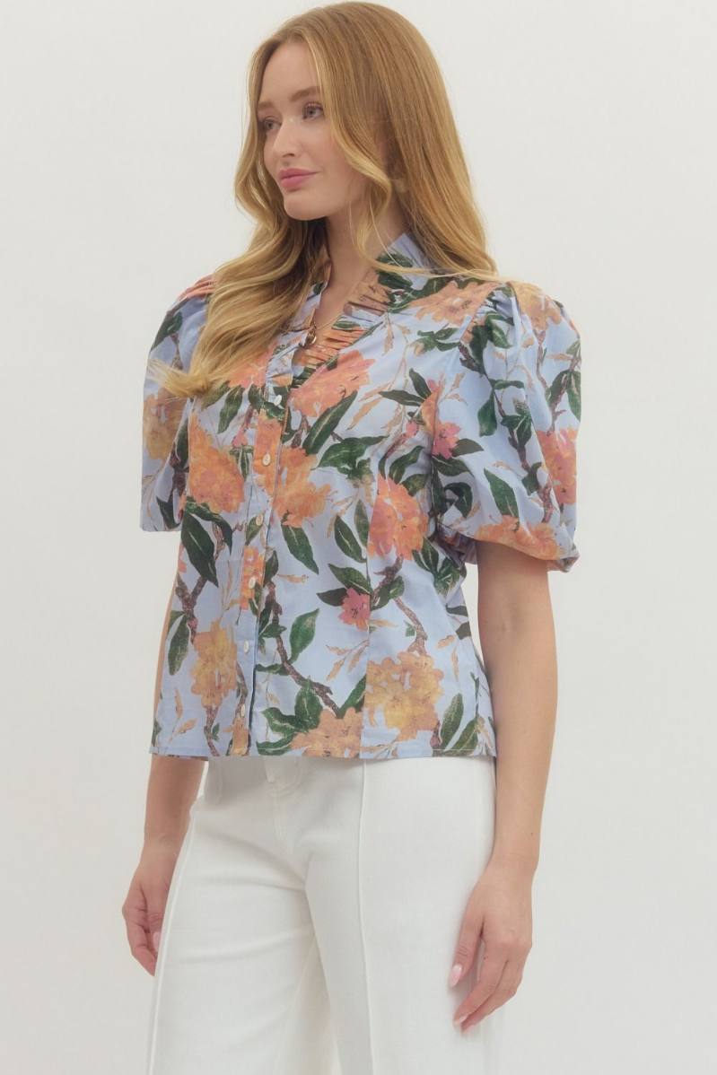 Woman wearing a floral blouse with a plain background