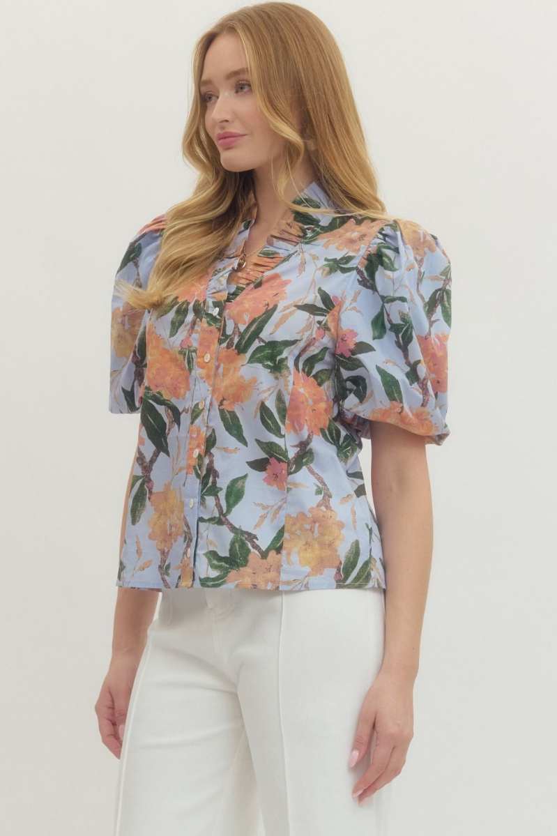 Woman wearing a floral blouse with a plain background