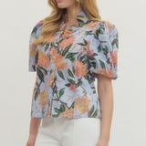 Woman wearing a floral blouse with a plain background