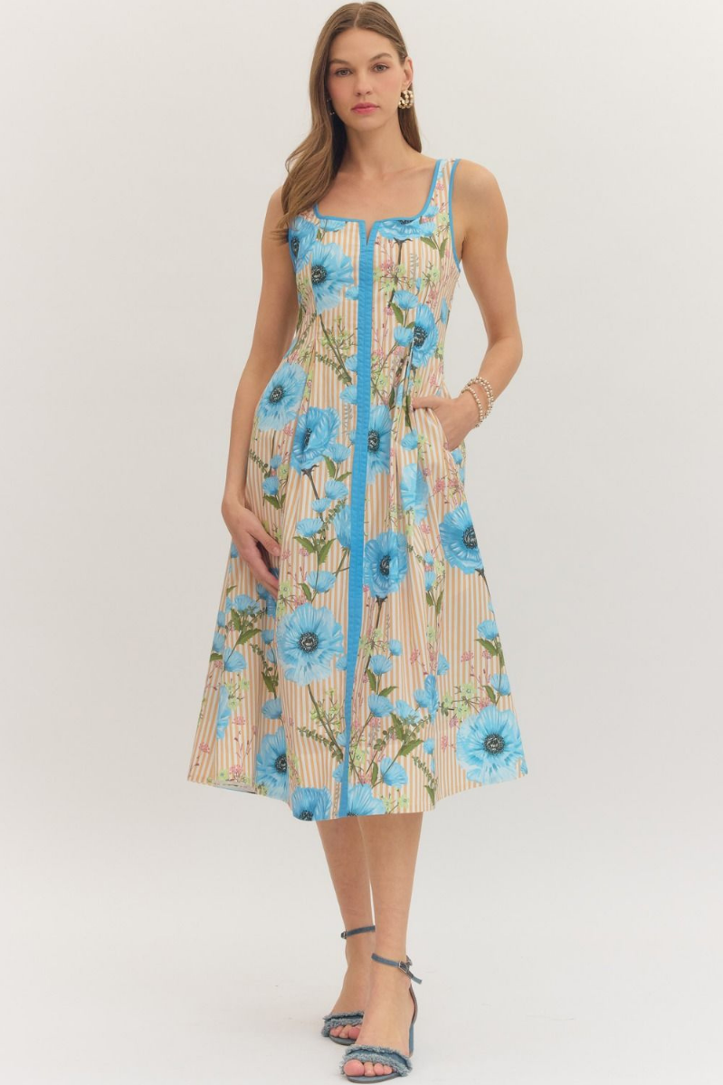 Woman wearing a floral dress with blue flowers on a white background