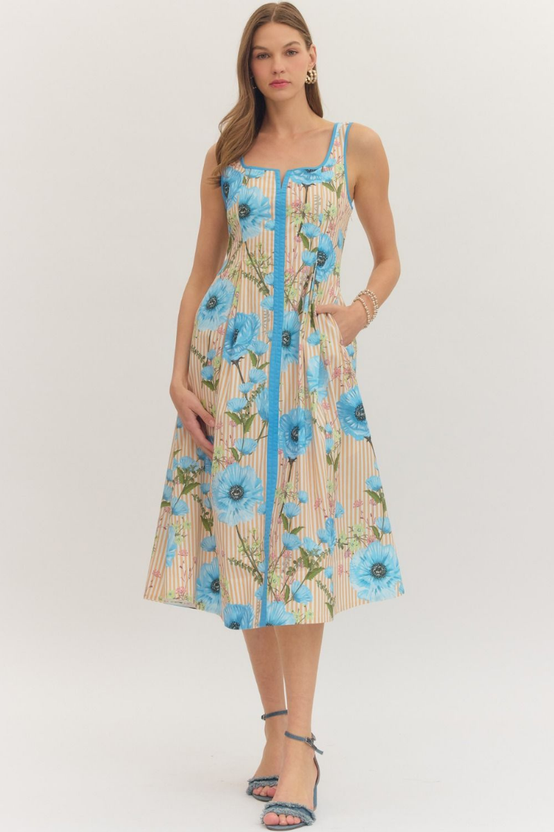 Woman wearing a floral dress with blue flowers on a white background