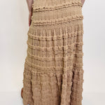 Brown tiered skirt with decorative elements on a white background