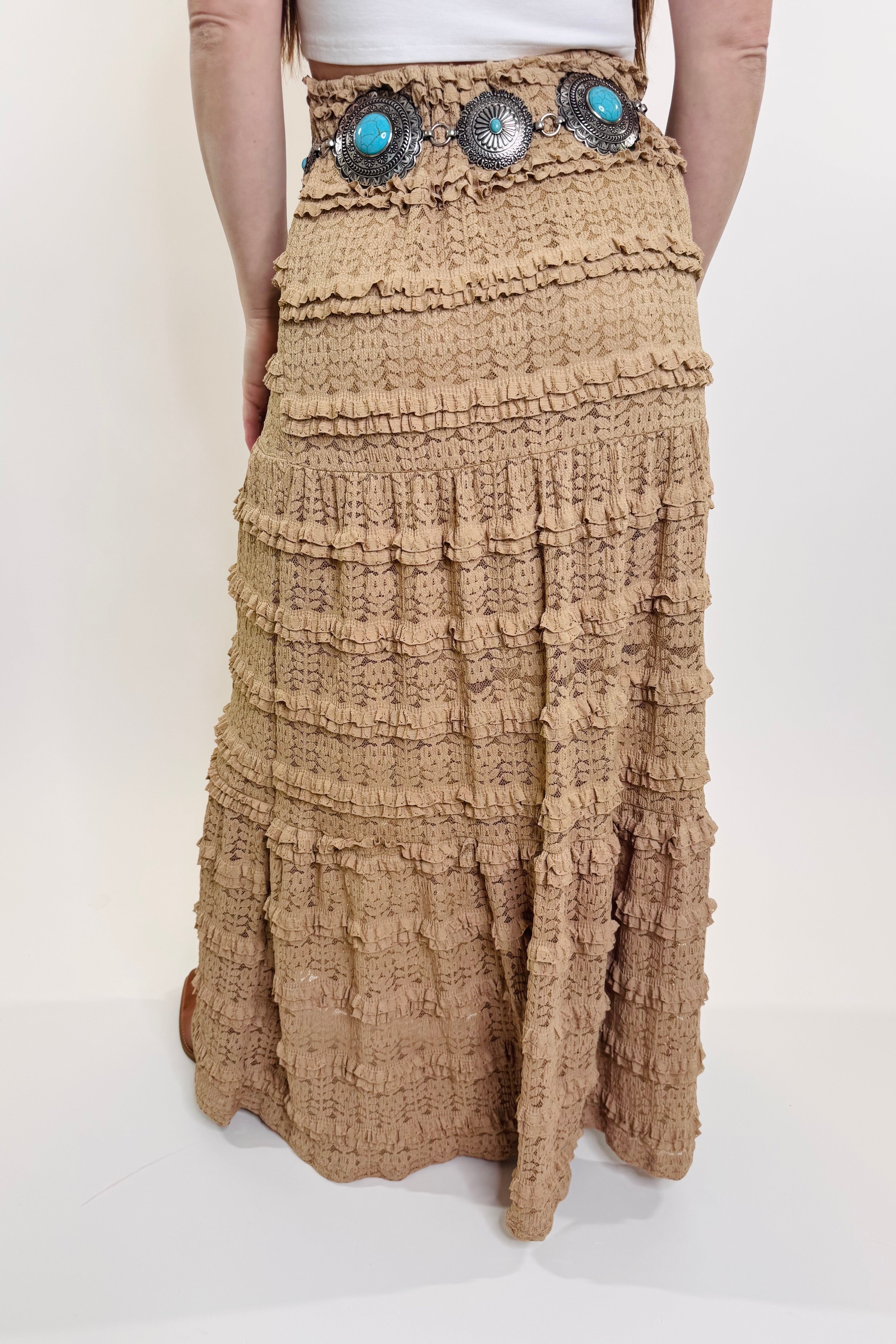 Brown tiered skirt with decorative elements on a white background