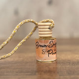 Small bottle with a string on a wooden surface