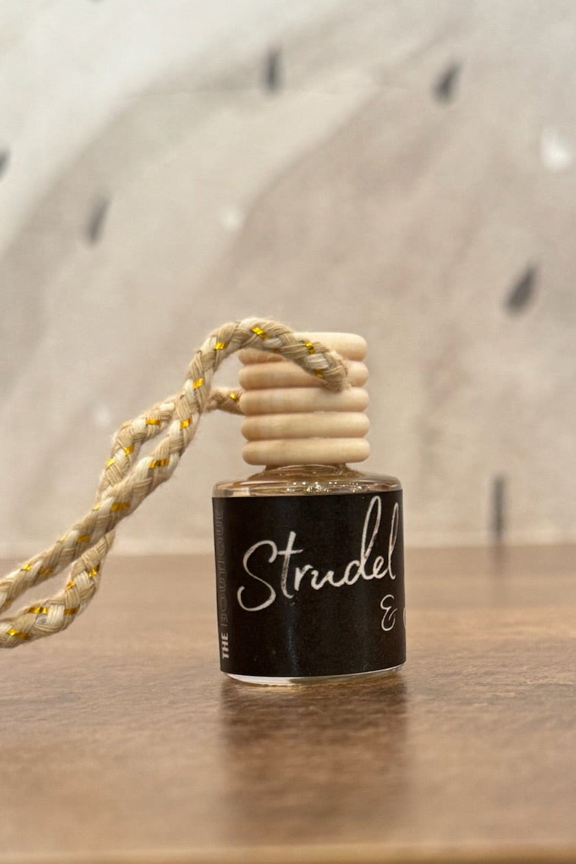 Small bottle with a wooden cap on a wooden surface