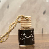 Small bottle with a wooden cap on a wooden surface