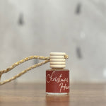 Small bottle with a wooden cap and string on a wooden surface with a blurred background