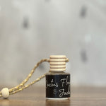 Small bottle with a wooden cap on a wooden surface, blurred background