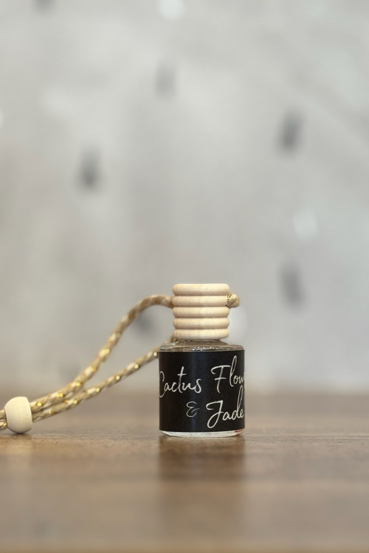Small bottle with a wooden cap on a wooden surface, blurred background