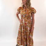 Woman wearing a floral dress against a white background