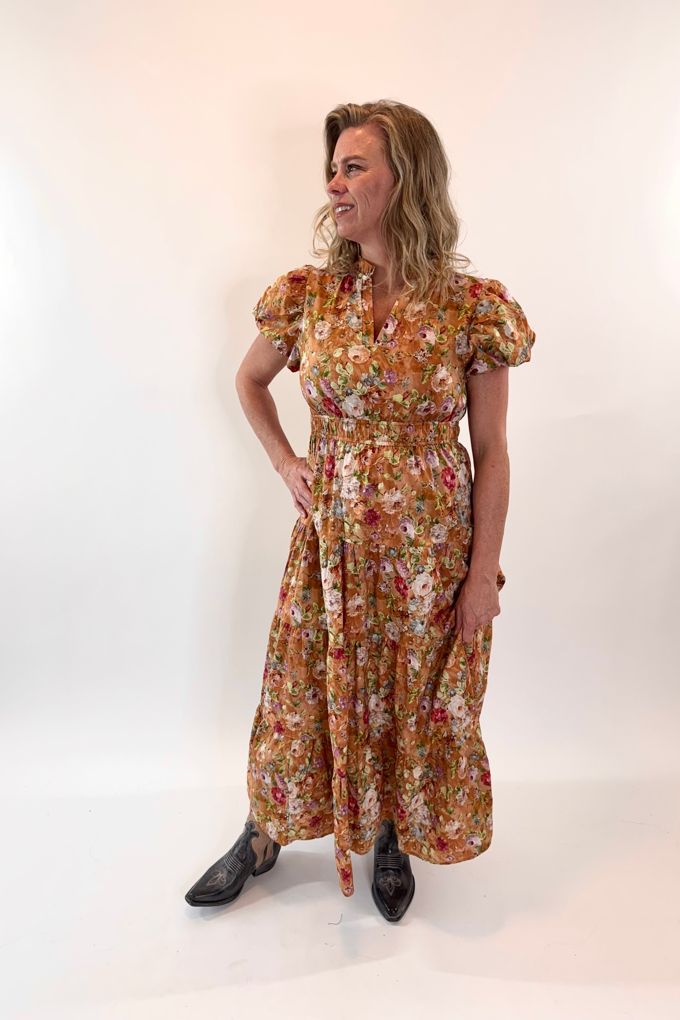 Woman wearing a floral dress against a white background