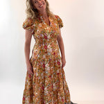 Woman wearing a floral dress against a white background